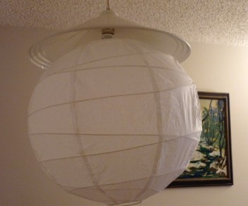 My dining room overhead light, with the original fixture and the lampshade I added