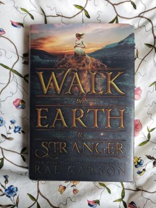 A hardcover copy of the novel Walk on Earth a Stranger by Rae Carson
